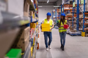 “warehouse workers carrying boxes in distribution center”